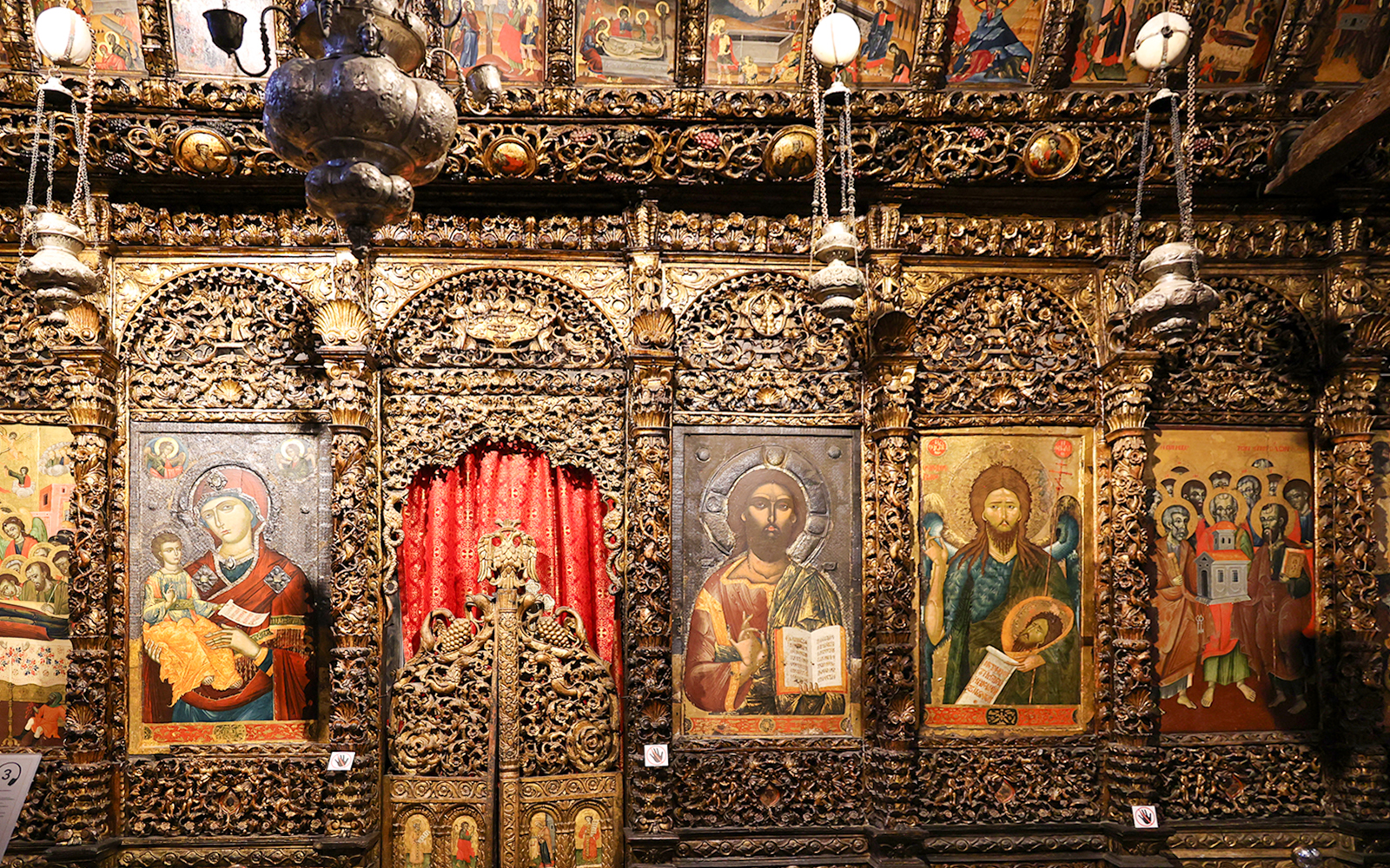 Iconography inside the Onufri National Iconographic Museum in Berat, featuring religious paintings and ornate carvings.