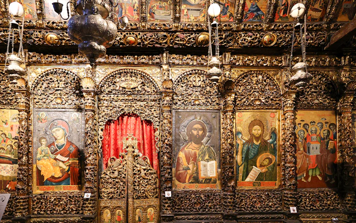 Iconography inside the Onufri National Iconographic Museum in Berat, featuring religious paintings and ornate carvings.
