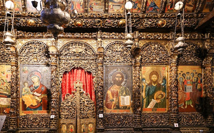 Iconography inside the Onufri National Iconographic Museum in Berat, featuring religious paintings and ornate carvings.