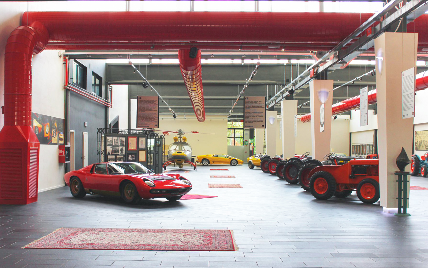Classic cars and tractors displayed at Ferruccio Lamborghini Museum in Bologna, Italy.