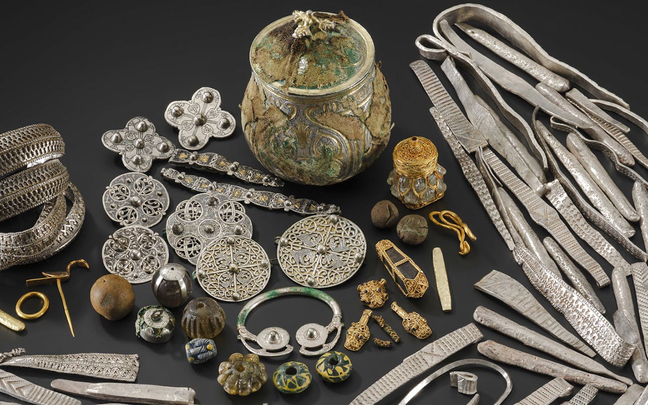 Galloway Hoard artifacts including silver brooches, arm rings, and gold jewelry from the Viking Age.