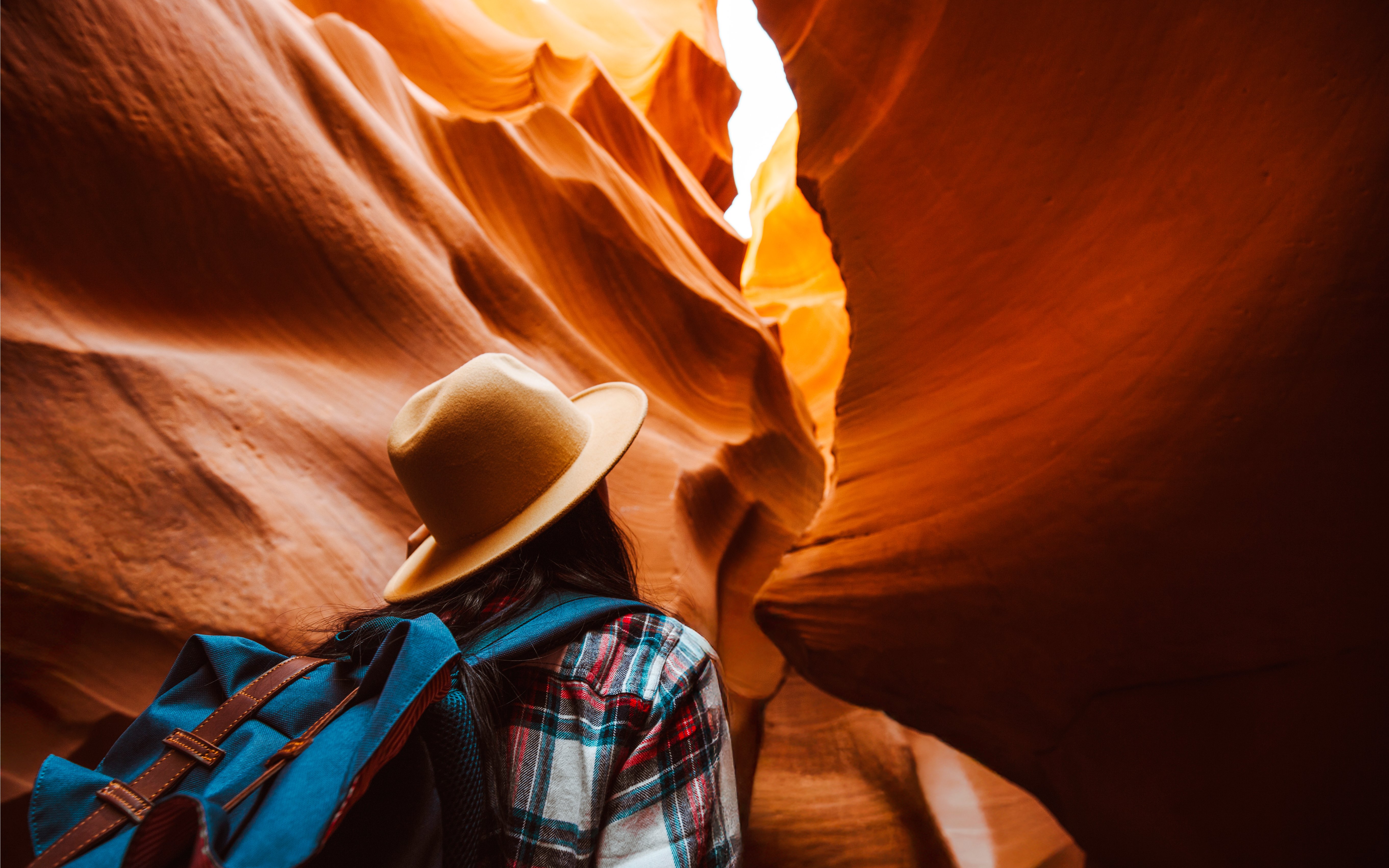 Traveler exploring the narrow sandstone formations of Rattlesnake Canyon.