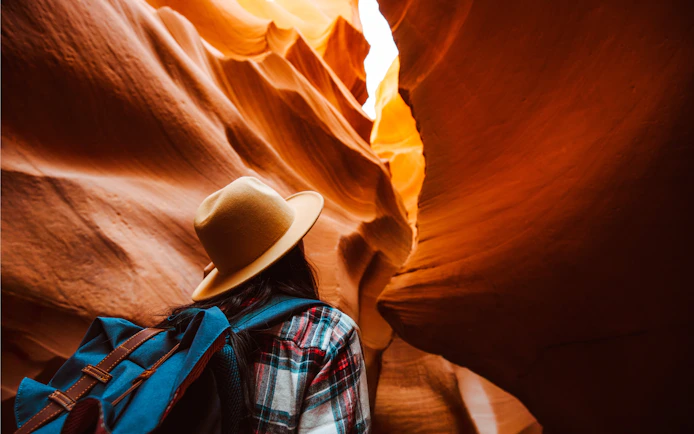 Traveler exploring the narrow sandstone formations of Rattlesnake Canyon.
