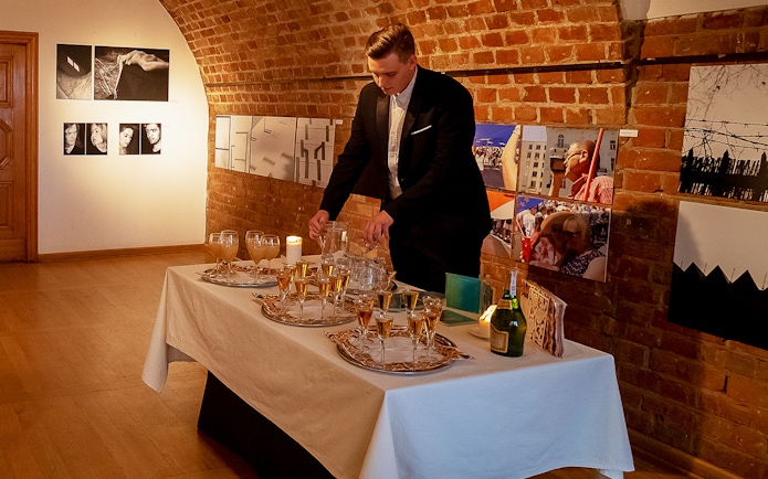 Server preparing drinks for Chopin recital at Old Town venue.