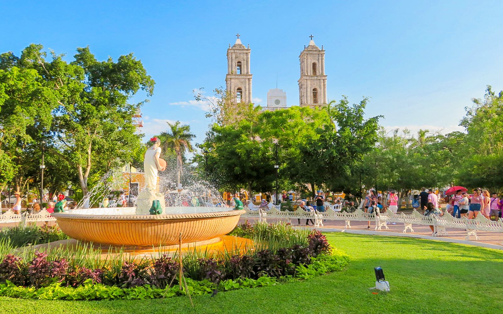 Fountain in a park with the Church of Valladolid, Yucatan, Mexico in the background.