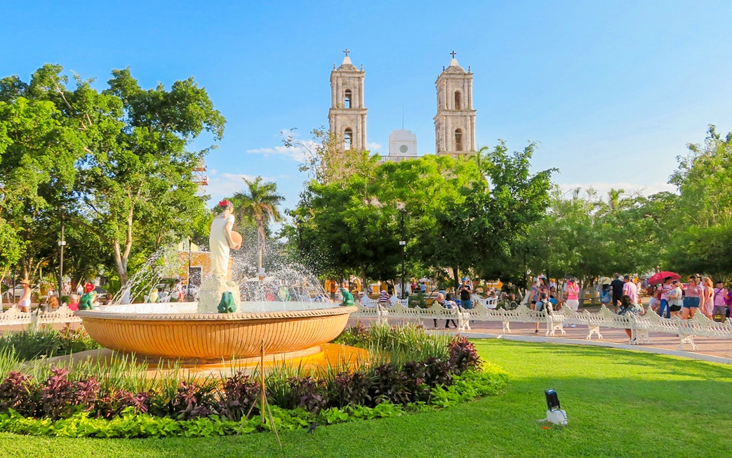 Fountain in a park with the Church of Valladolid, Yucatan, Mexico in the background.