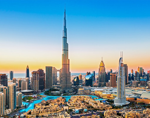 Dubai downtown skyline with Burj Khalifa at sunset.