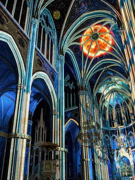 Votivkirche interior with colorful light projections, Vienna.
