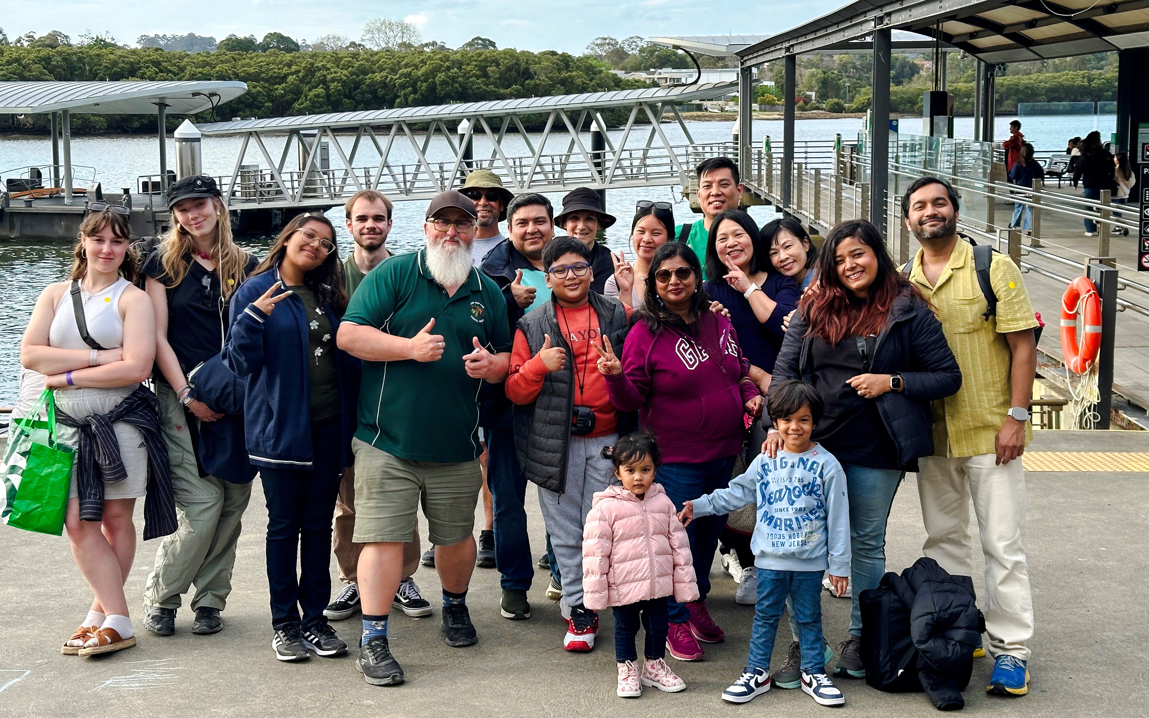 Group of tourists at a dock, preparing for Blue Mountains Zig Zag Train and Harbour Cruise tour.