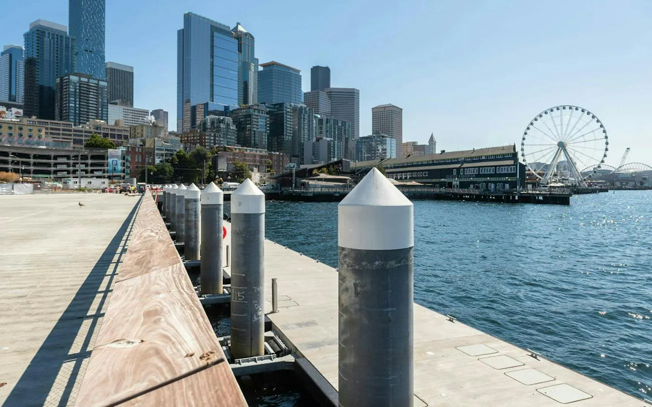 Seattle waterfront with skyline and Ferris wheel, part of the Harbor of Secrets Golden Mermaid Hunt game.