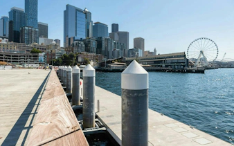 Seattle waterfront with skyline and Ferris wheel, part of the Harbor of Secrets Golden Mermaid Hunt game.