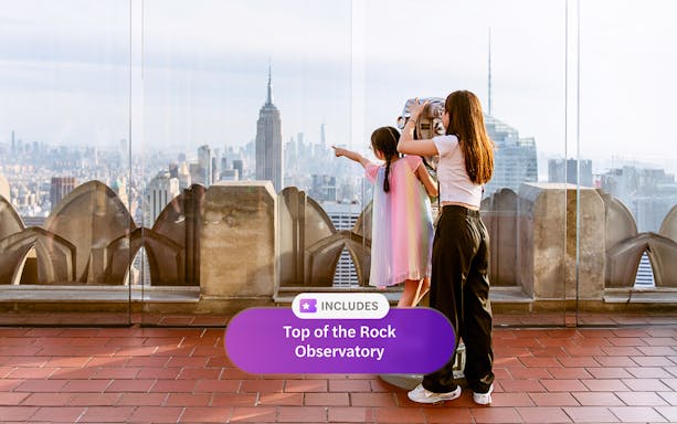 Visitors enjoying the view from Top of the Rock Observatory, New York City skyline in background.