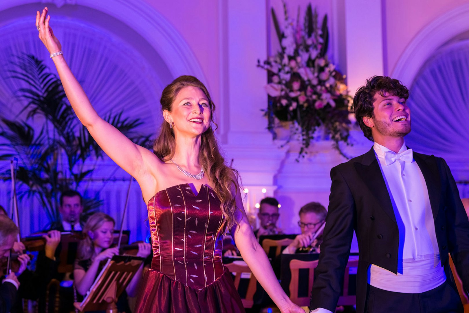Performers at Mozart and Strauss concert in Kursalon Vienna with orchestra in background.