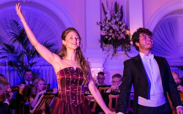 Performers at Mozart and Strauss concert in Kursalon Vienna with orchestra in background.