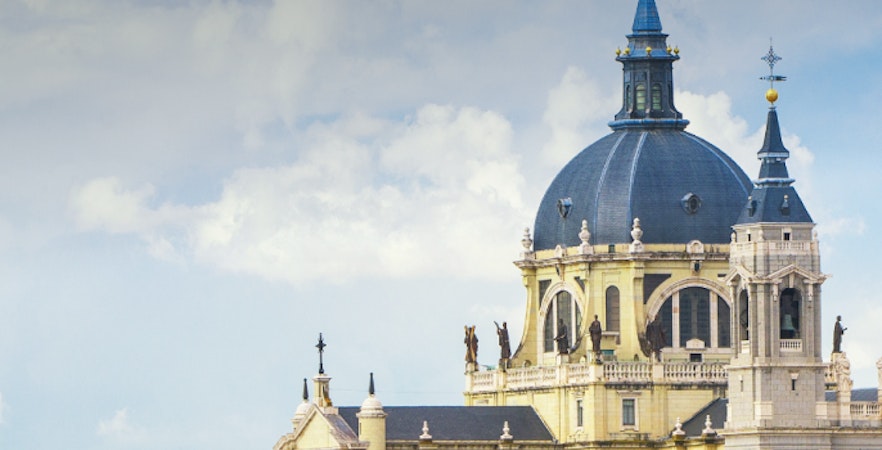 Madrid cityscape with Royal Palace and Almudena Cathedral in the background.