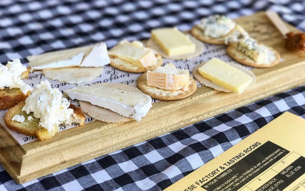 Cheese platter with various cheeses on crackers, part of a Hunter Valley wine tasting tour.