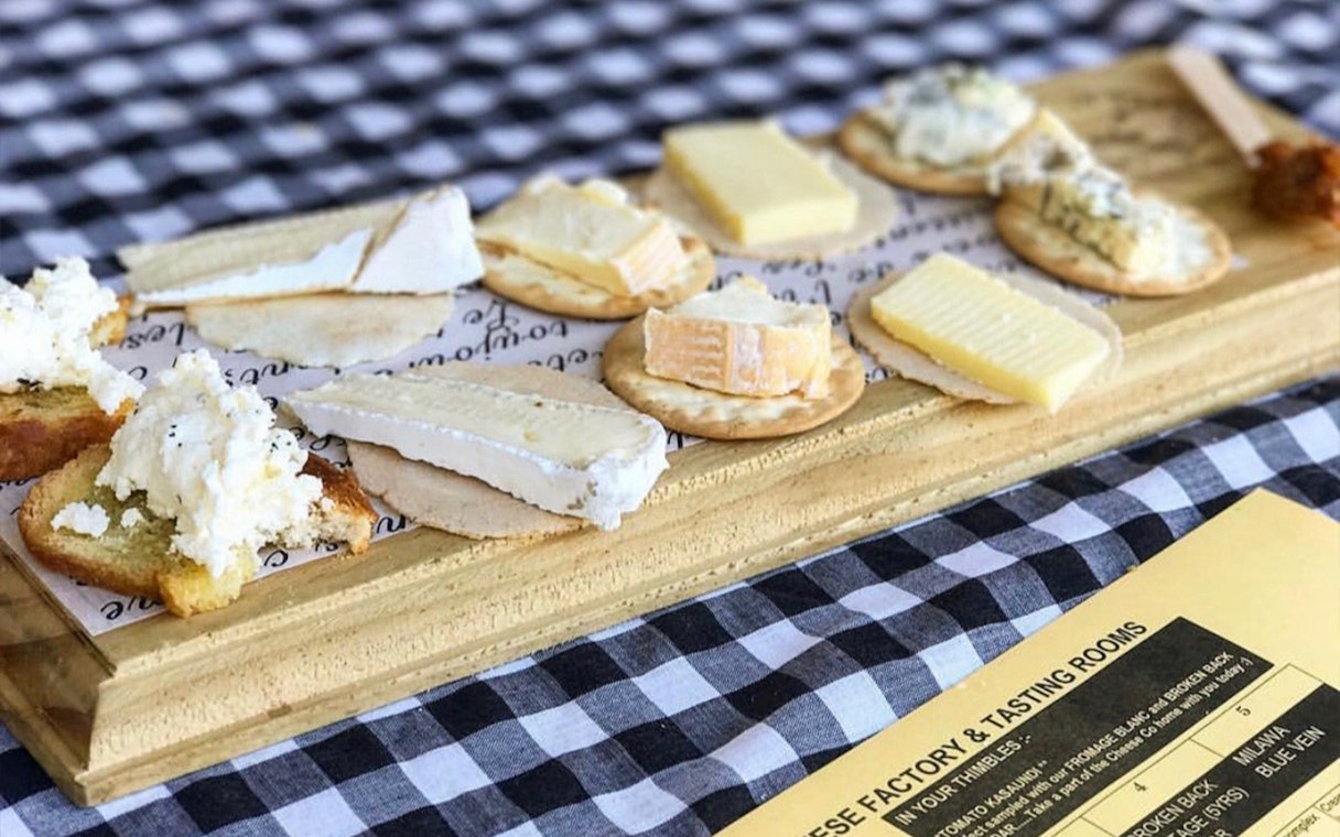 Cheese platter with various cheeses on crackers, part of a Hunter Valley wine tasting tour.