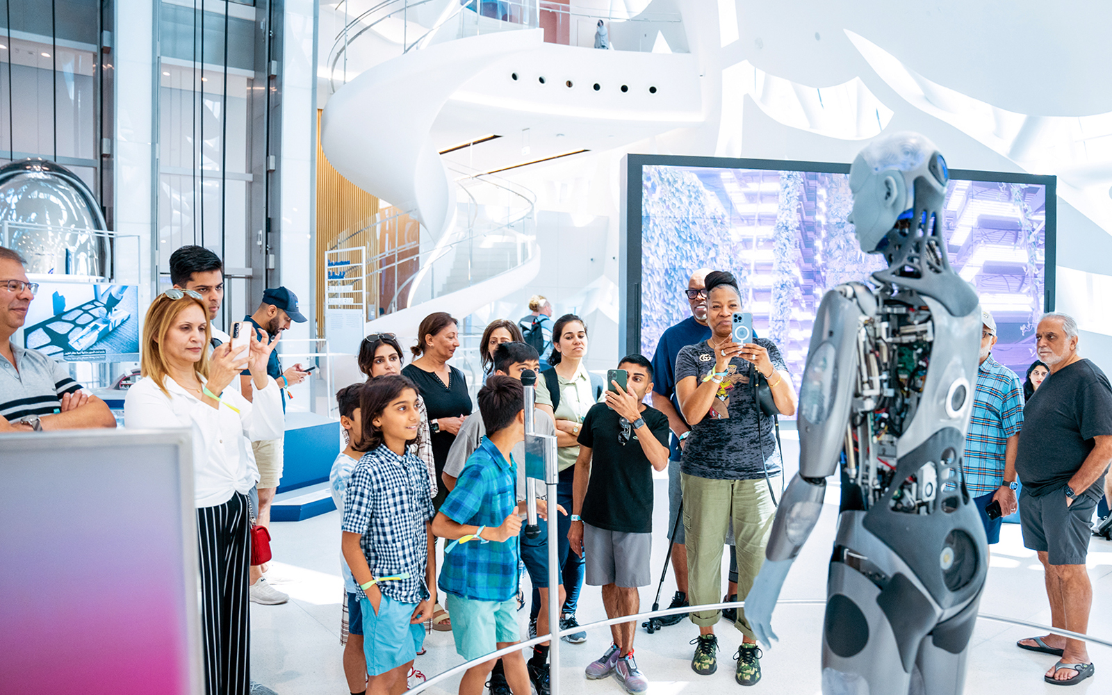 Visitors interacting with a robot at Dubai's Museum of The Future, Pioneer Pass access.