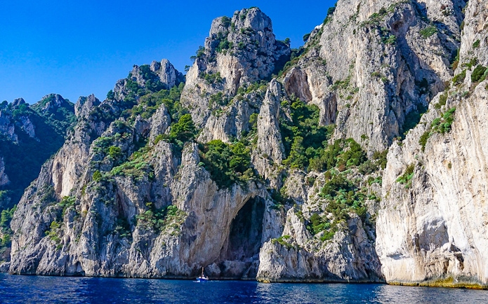 White Grotto entrance on Capri's rocky coastline, Italy.