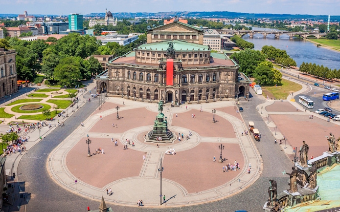 Semperoper Dresden with surrounding square and Elbe River in the background.