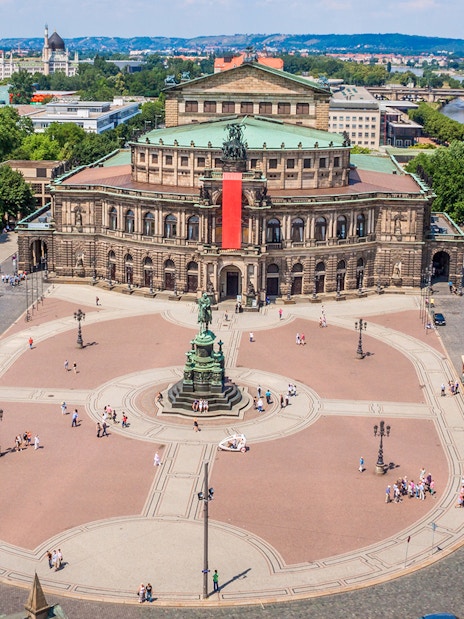 Semperoper Dresden with surrounding square and Elbe River in the background.
