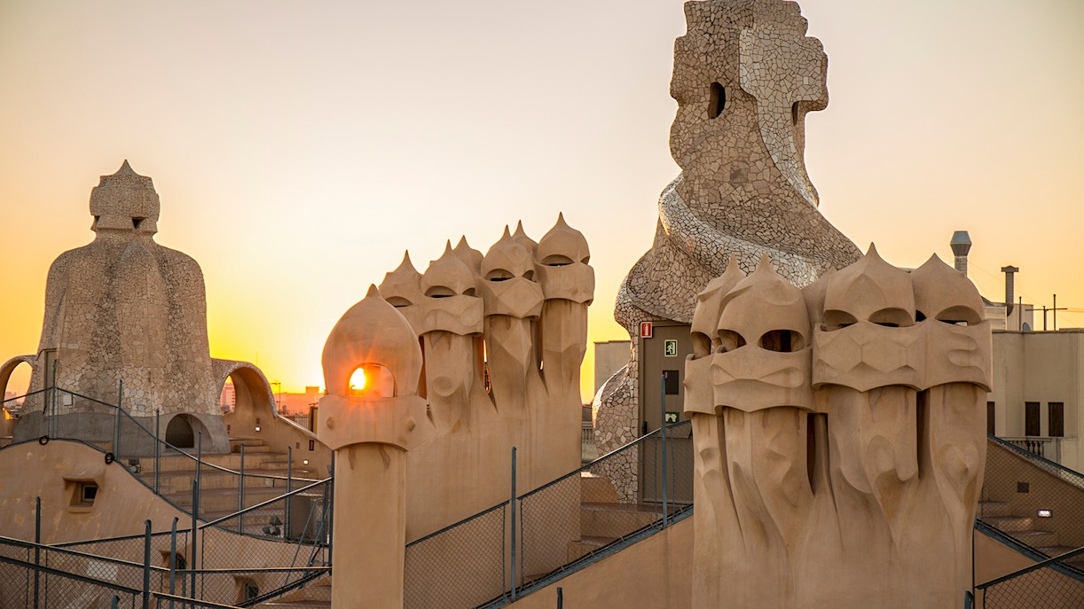 Rooftop chimneys of Casa Milà at sunrise during La Pedrera tour in Barcelona.