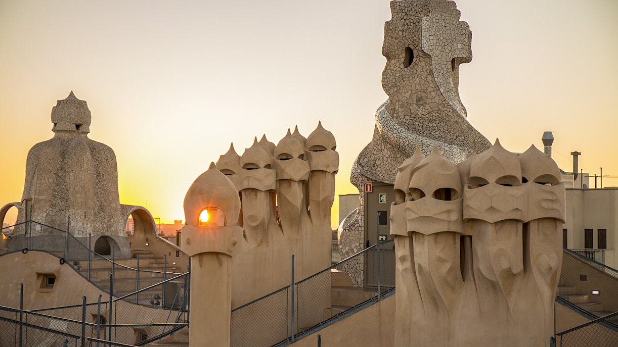Rooftop chimneys of Casa Milà at sunrise during La Pedrera tour in Barcelona.