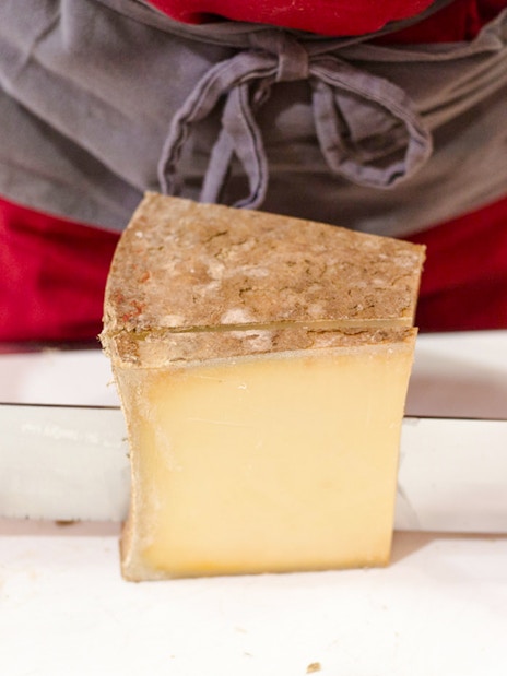 Cutting cheese at the Cheese Museum in Paris, France.