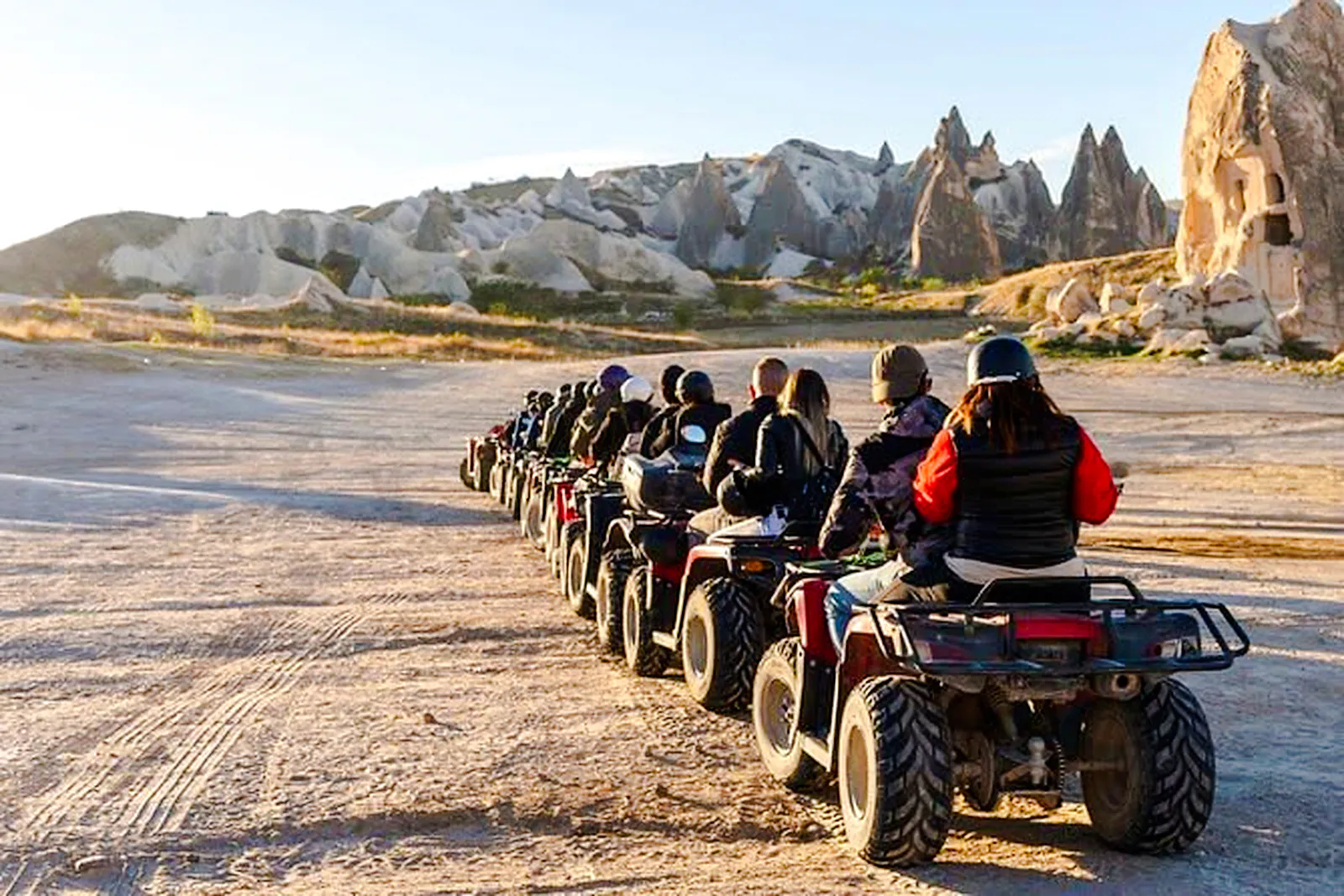 ATV riders exploring Cappadocia's rocky landscape during a tour.