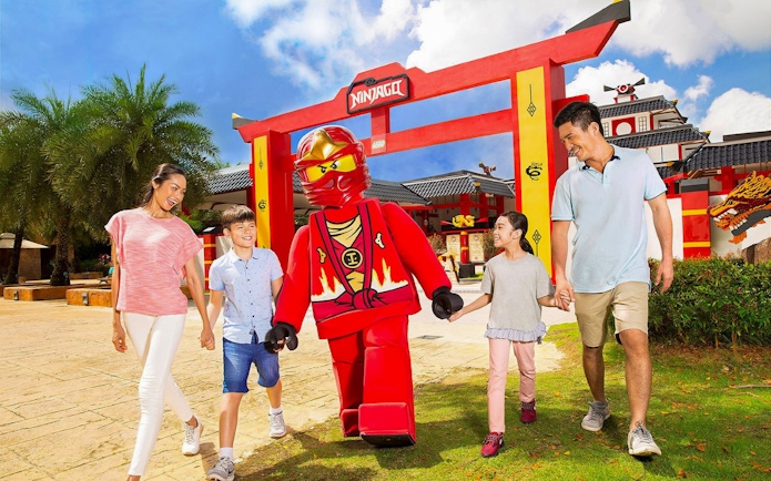 Family walking with LEGO Ninjago character at LEGOLAND Malaysia.