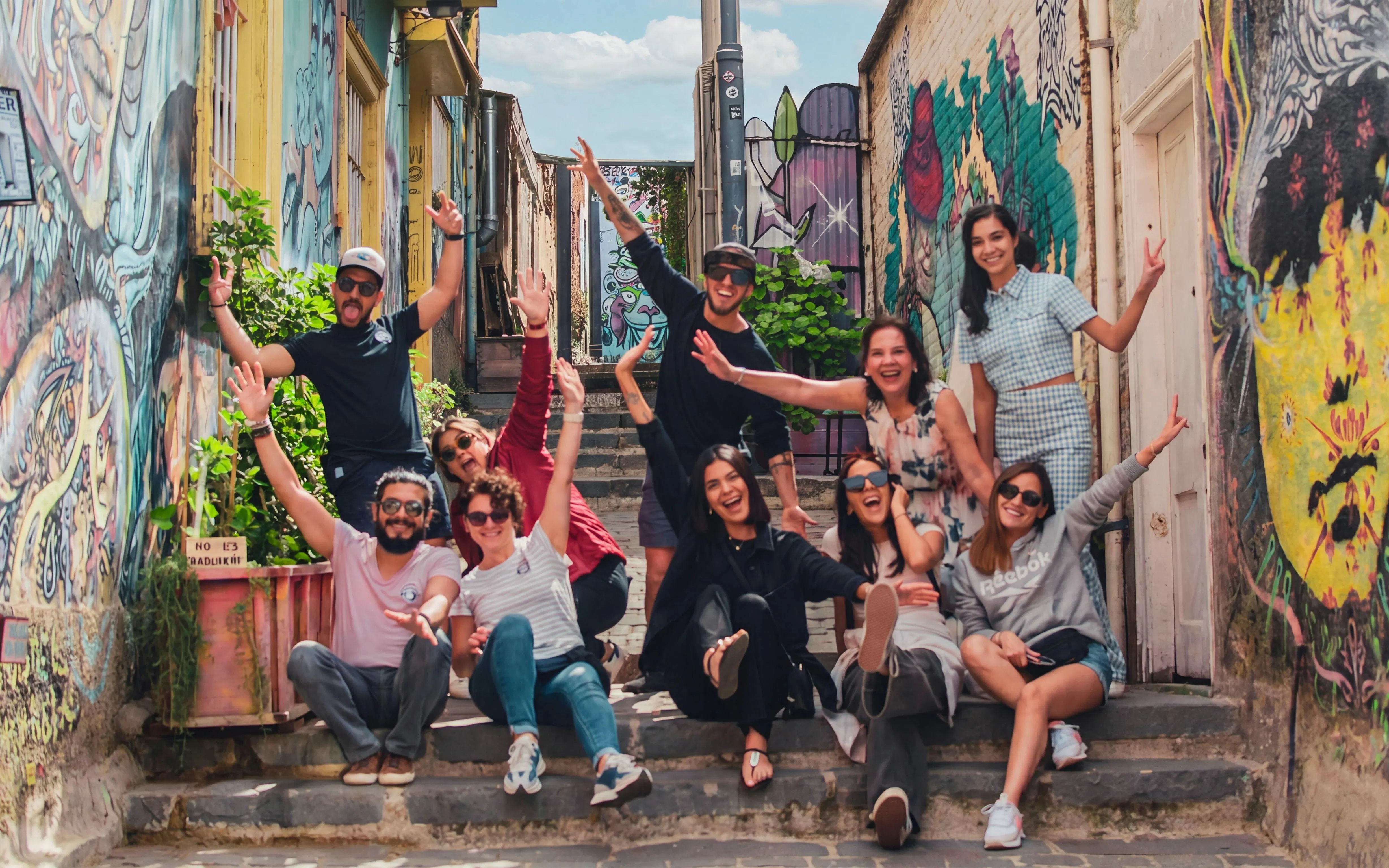 Group enjoying colorful street art in Valparaíso, Chile's historic district.