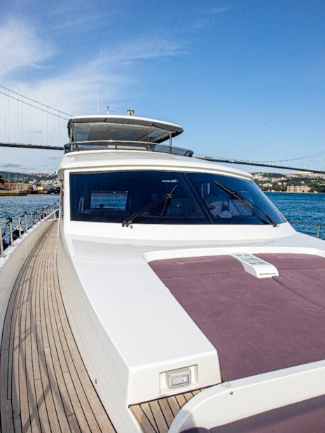 Bosphorus cruise boat with Ortaköy Mosque and Bosphorus Bridge in Istanbul.
