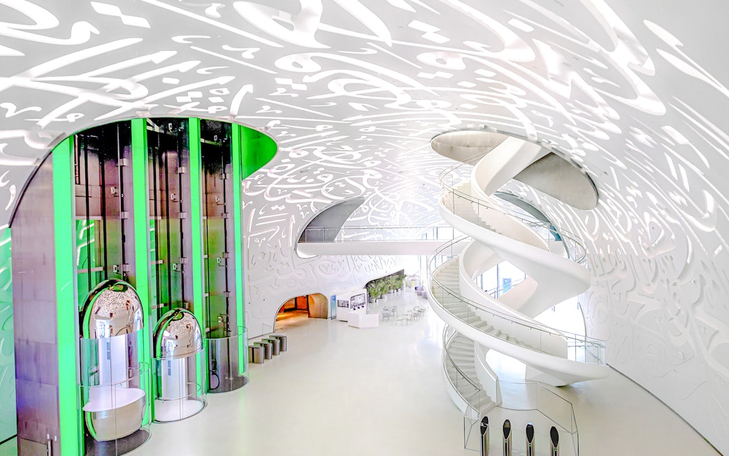 Futuristic interior of Museum of the Future in Dubai with spiral staircase and illuminated walls.