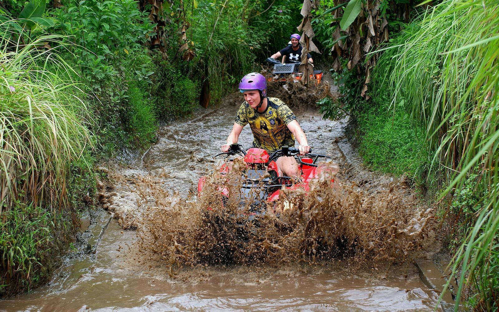 Quad biking through muddy trails in Bali.