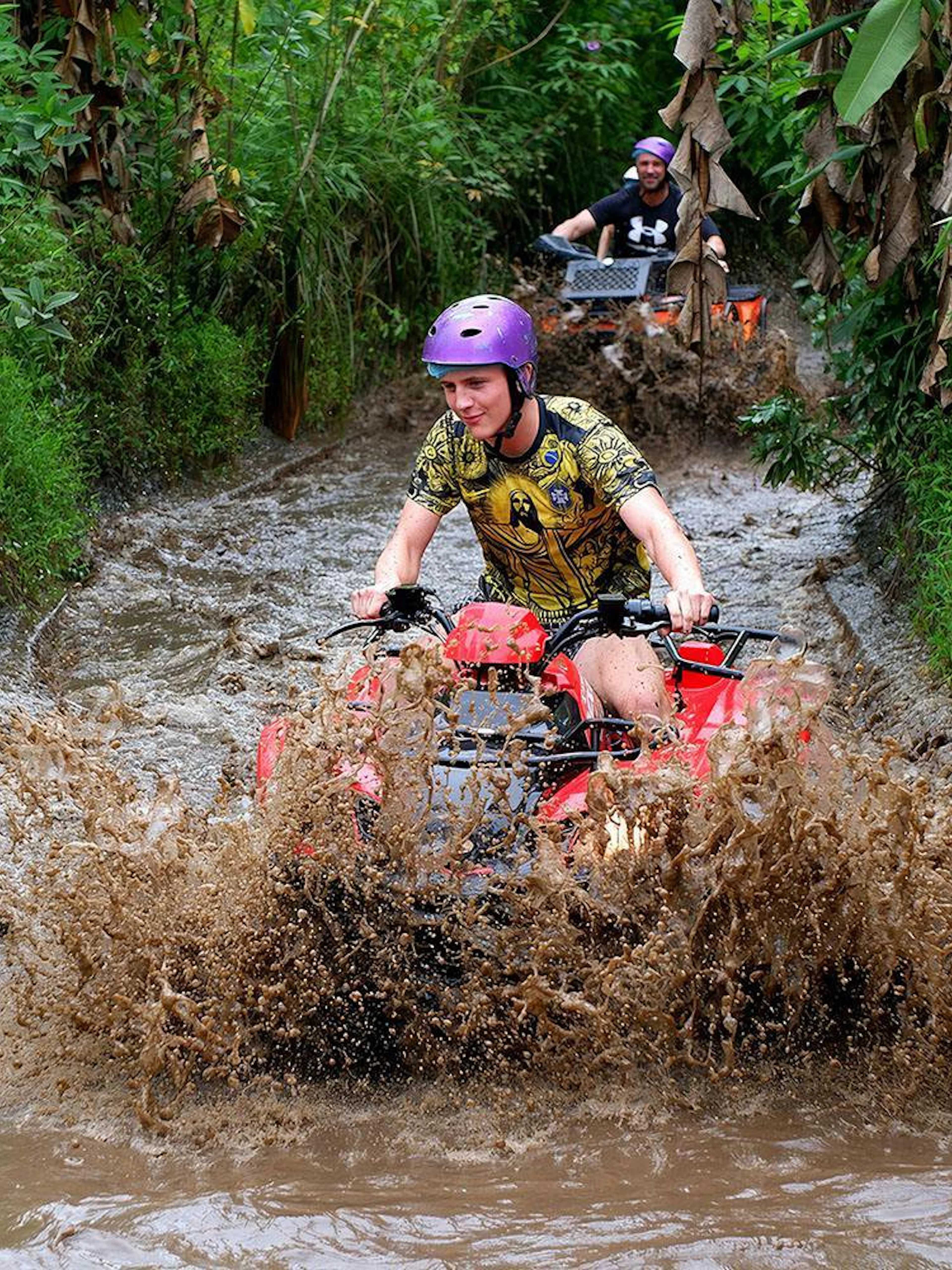 Quad biking through muddy trails in Bali.