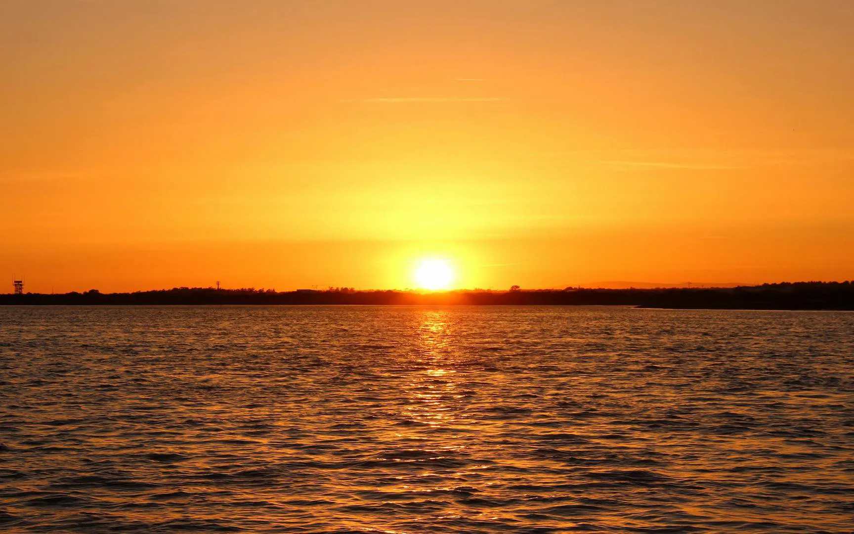 Sunset over Ria Formosa lagoon during a boat tour.