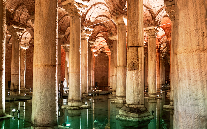 Basilica Cistern's illuminated columns and arches in Istanbul.