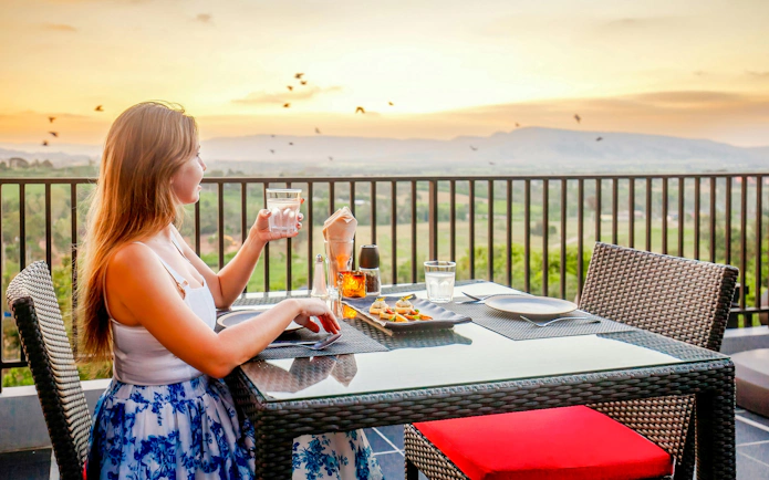 Dining with a view of the Delphi landscape at sunset, Greece.