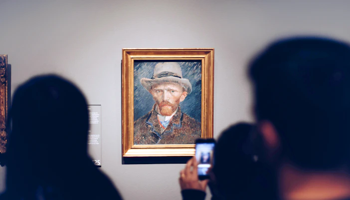 Visitors viewing a Van Gogh self-portrait at the Van Gogh Museum.
