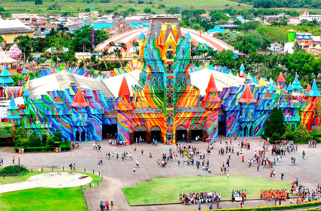 Colorful entrance of Beto Carrero World theme park with visitors, Santa Catarina, Brazil.
