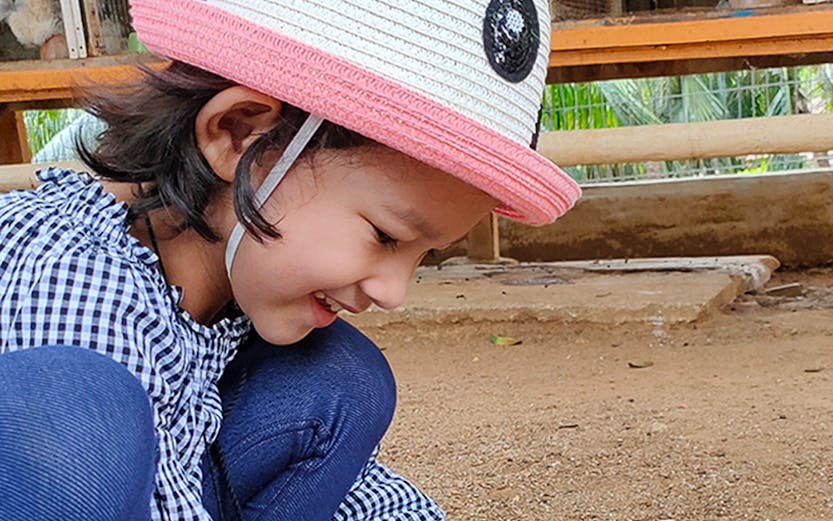 Child petting a rabbit at Melaka Crocodile & Recreational Park.