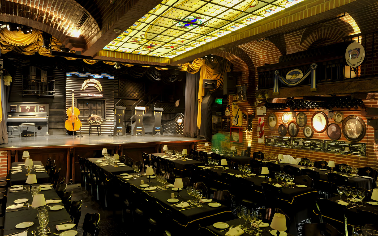 Elegant theater setup for Piazzolla Tango Show in Buenos Aires, featuring stage and dining tables.