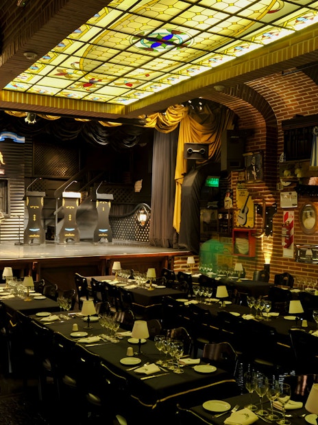 Elegant theater setup for Piazzolla Tango Show in Buenos Aires, featuring stage and dining tables.