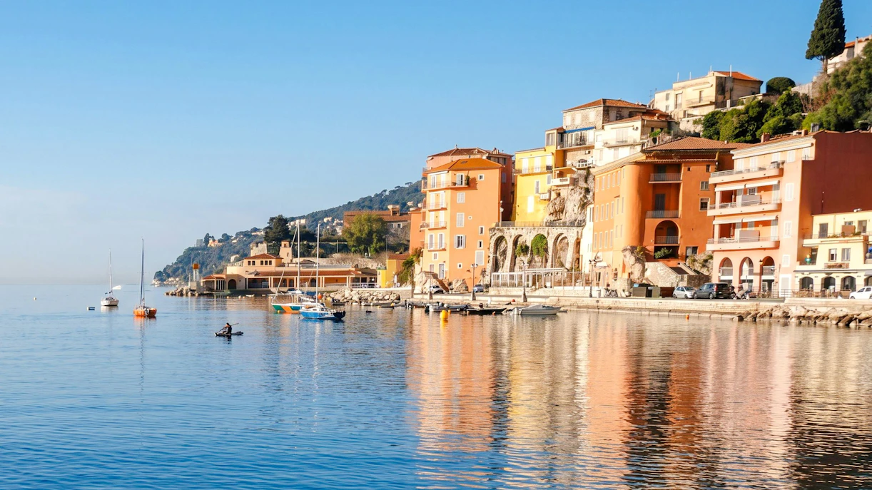 Villefranche coastline with colorful buildings and boats on a tour to Monaco.