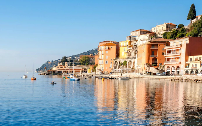 Villefranche coastline with colorful buildings and boats on a tour to Monaco.