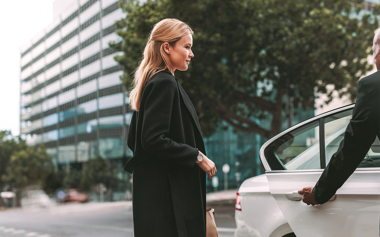 A woman getting into a car