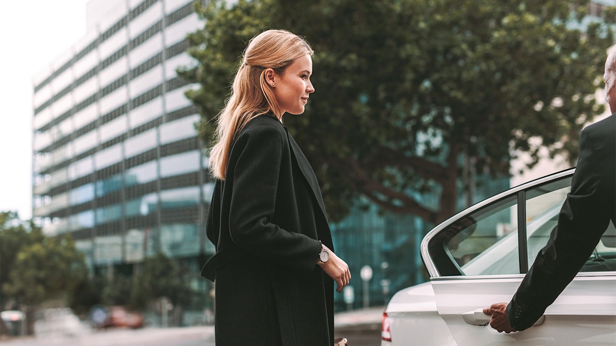 A woman getting into a car