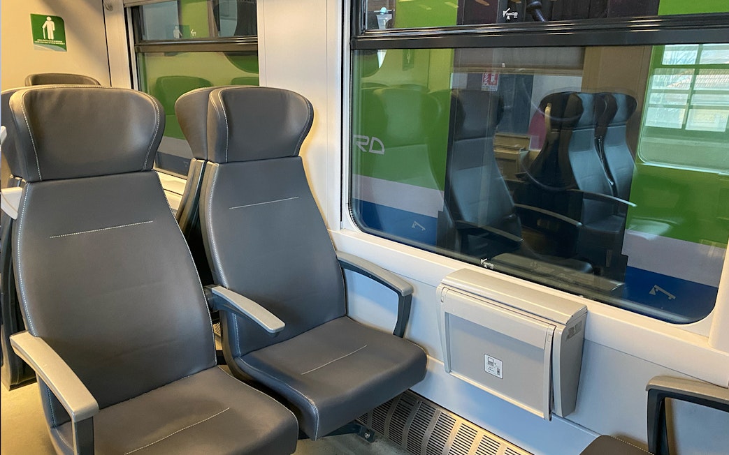 Train seats on route between Milan Malpensa Airport and Milan Central Station.