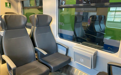 Train seats on route between Milan Malpensa Airport and Milan Central Station.