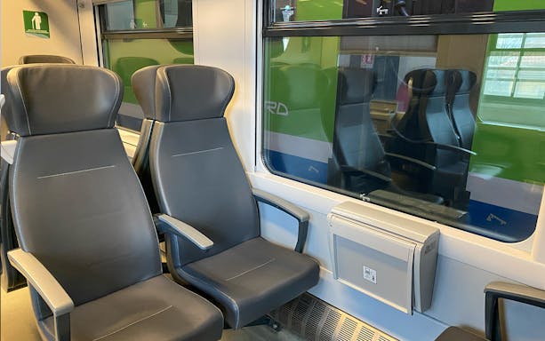 Train seats on route between Milan Malpensa Airport and Milan Central Station.